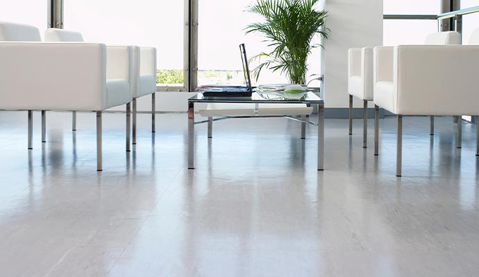 double charged porcelain tiles view of white armchairs spacious and modern flooring